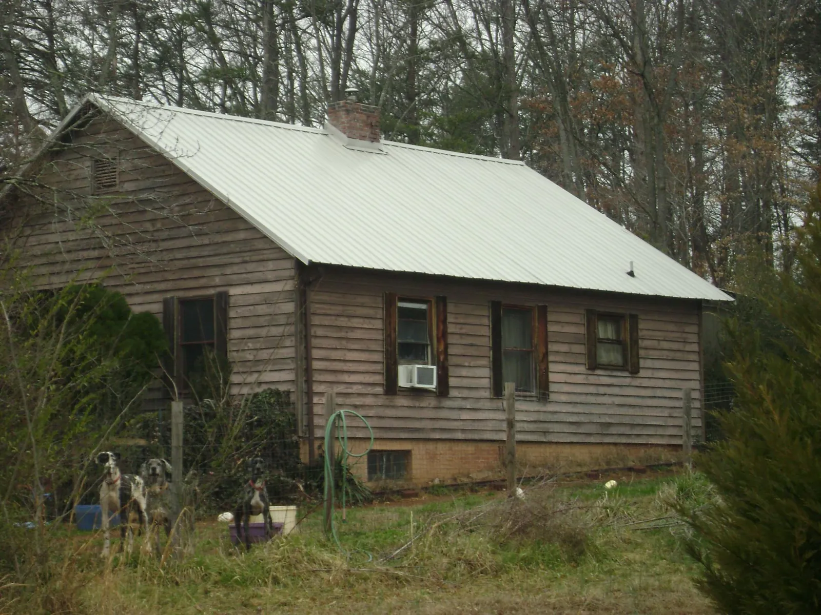 White metal roof on an old wood sided farmhouse, from a Metal Roof Installation job in Shannock